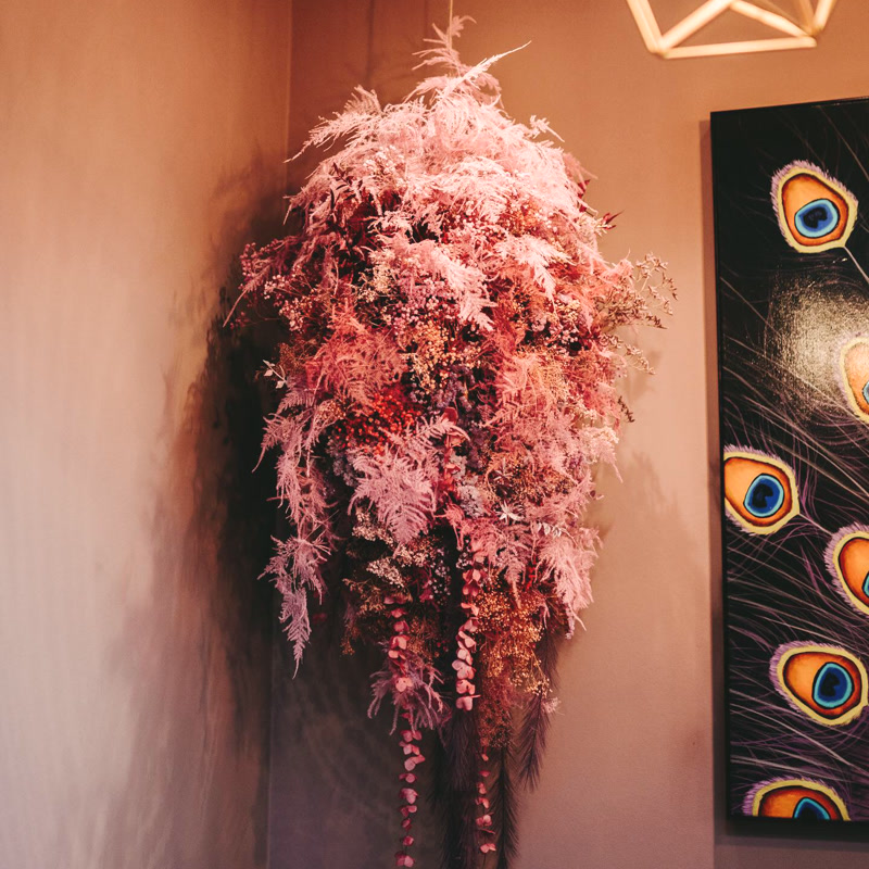 Grande suspension de fleurs séchées roses dans un salon