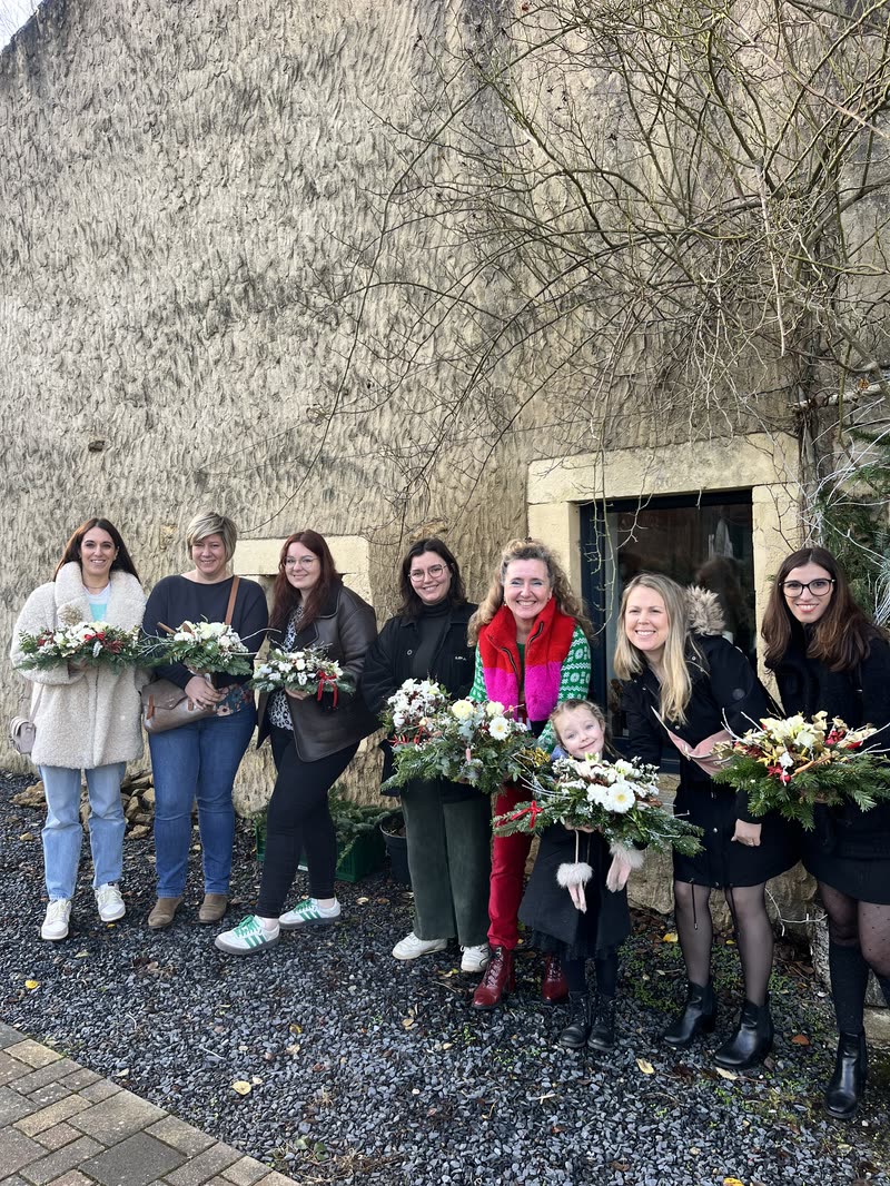 Groupe d'un atelier avec ses bouquets, devant l'atelier