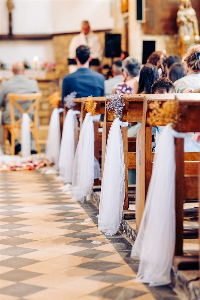 Bancs d'église ornés de tulle et de gypsophile