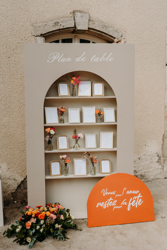 Plan de table installé dans une niche et souligné de fleurs orange
